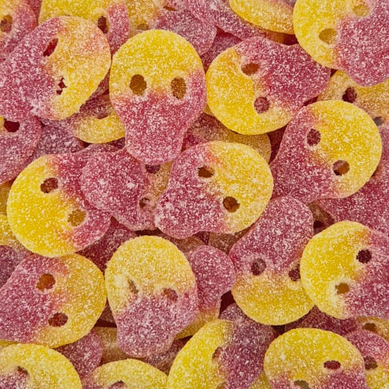 A clear plastic container filled with round, sugar-coated candy pieces in pink and yellow, photographed from above on a plain light background.