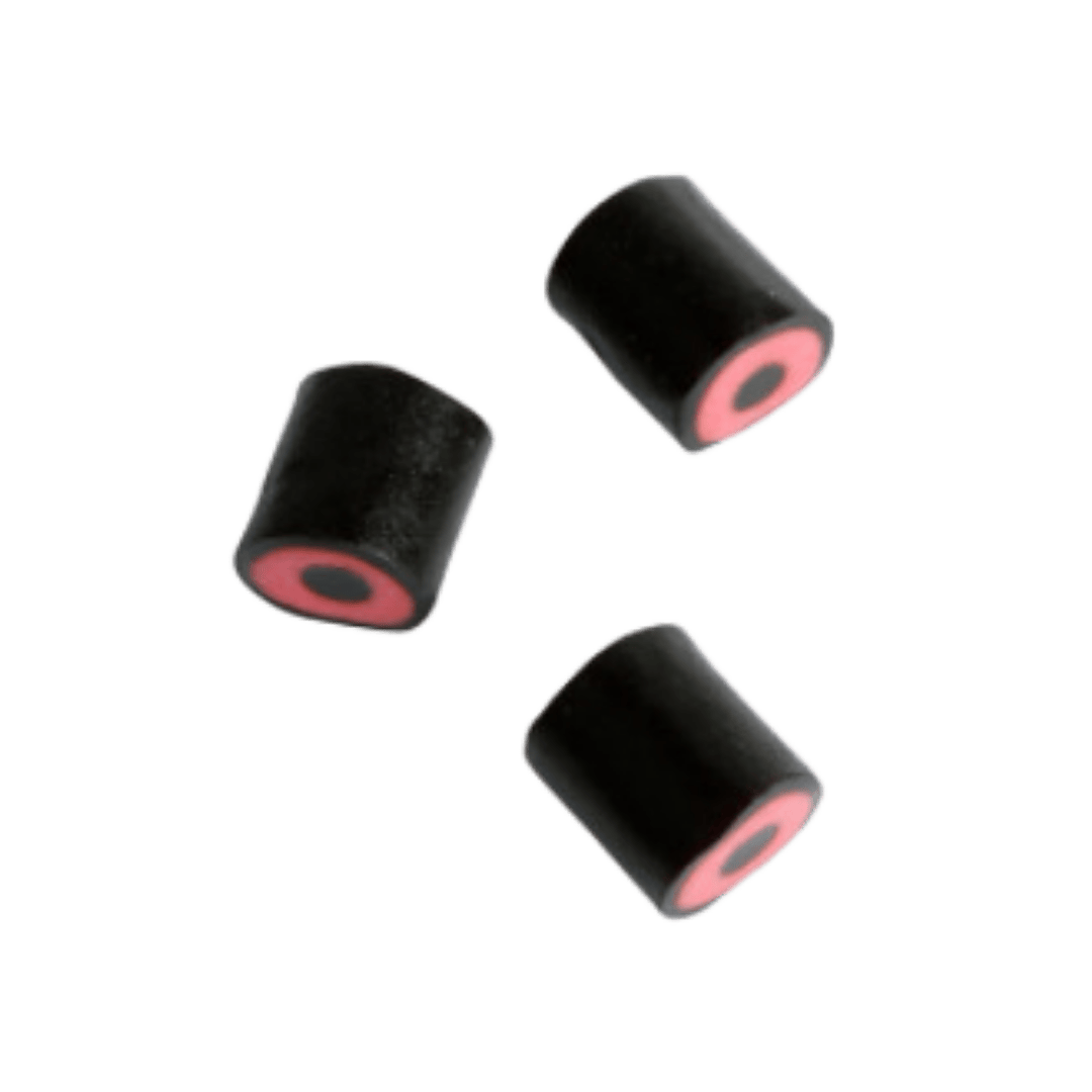 Three black candies with red licorice cores, displayed against a green background.