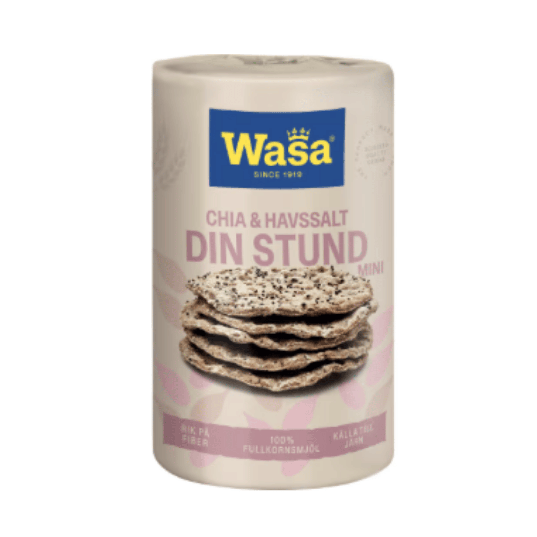 A cylindrical container of Wasa Chia and Flaxseed Salt Mini, featuring a cream-colored label with a blue brand logo and an image of two salted flatbreads, set against a solid green background.
