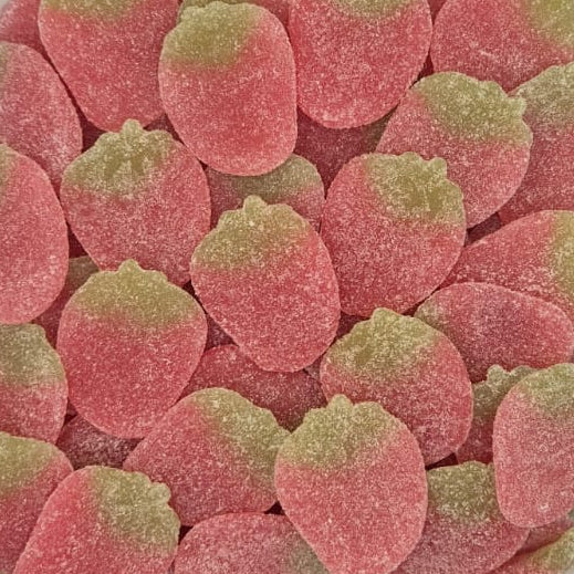 A clear plastic container filled with strawberry-shaped gummy candies coated in pink sugar, with light green tops, photographed from above on a white surface.