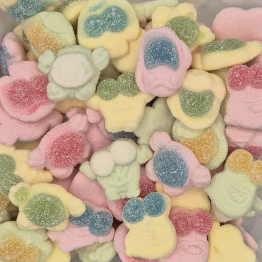 A clear plastic container filled with small, colorful, character-shaped sour candies on a plain light background.