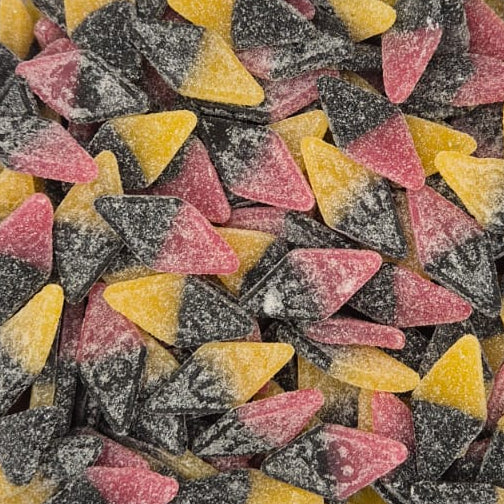 A clear plastic square container filled with small triangular candies in pink, yellow, and dark gray/black, photographed from above on a white surface.