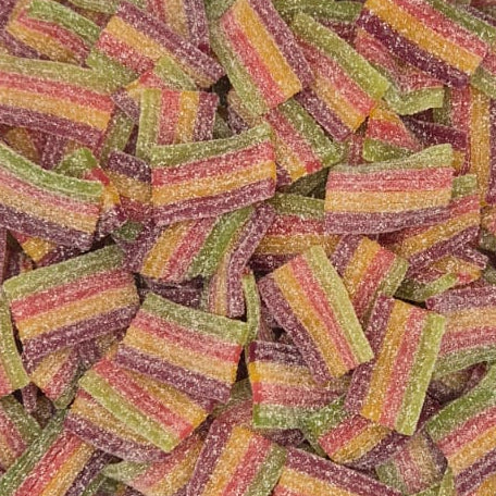 A clear plastic tub filled with many small rectangular candy pieces wrapped in pink, orange, yellow, and green striped paper, photographed on a plain white surface.