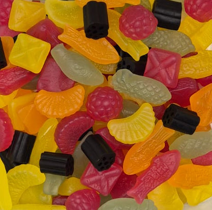 Assorted colorful gummy candies in a clear container on a white background