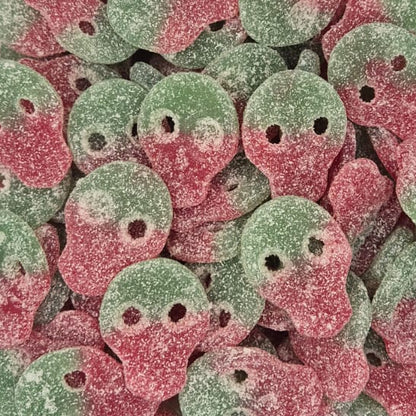 A clear plastic container filled with small round candy pieces coated in pink and green sugar, photographed from above on a white surface.