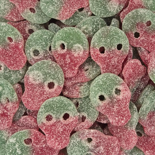 A clear plastic container filled with small round candy pieces coated in pink and green sugar, photographed from above on a white surface.