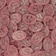 A close-up pile of oval pink candy-coated chocolates or gummies, coated in a fine white sugar dusting. Picture of S -Märke , the famous Swedish Candy