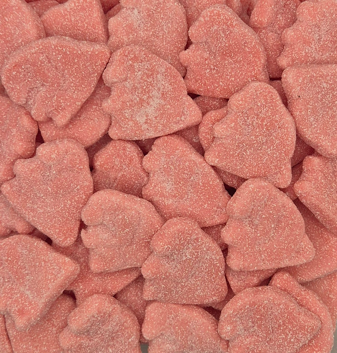 A close-up pile of small, heart-shaped candy pieces coated in a fine pink sugar dusting.