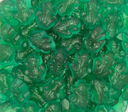 A close-up pile of translucent green gummy candies shaped like frogs, filling the entire frame.
