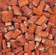 A close-up pile of reddish-brown rectangular candies coated in sugar, with some showing white cream or biscuit-like centers.