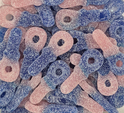 A clear plastic tub filled with pink and blue loop-shaped sour candy pieces, photographed against a plain light background.