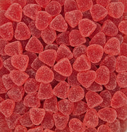 A close-up, top-down view of many small, heart-shaped red gummy candies with a frosted sugar coating, filling the entire frame.