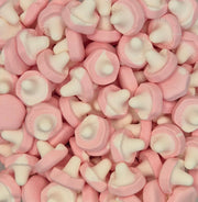 A close-up pile of pink and white mushroom-shaped candies or gummy sweets filling the frame.