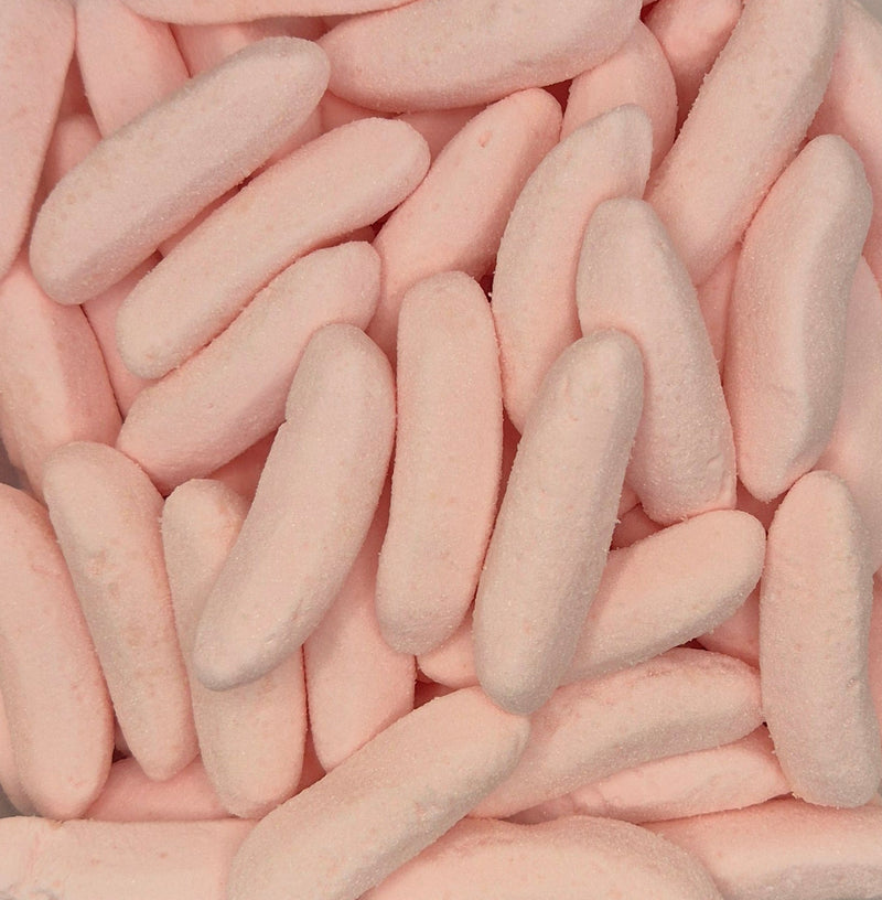A close-up pile of pale pink, elongated marshmallow candies with a soft, textured surface.