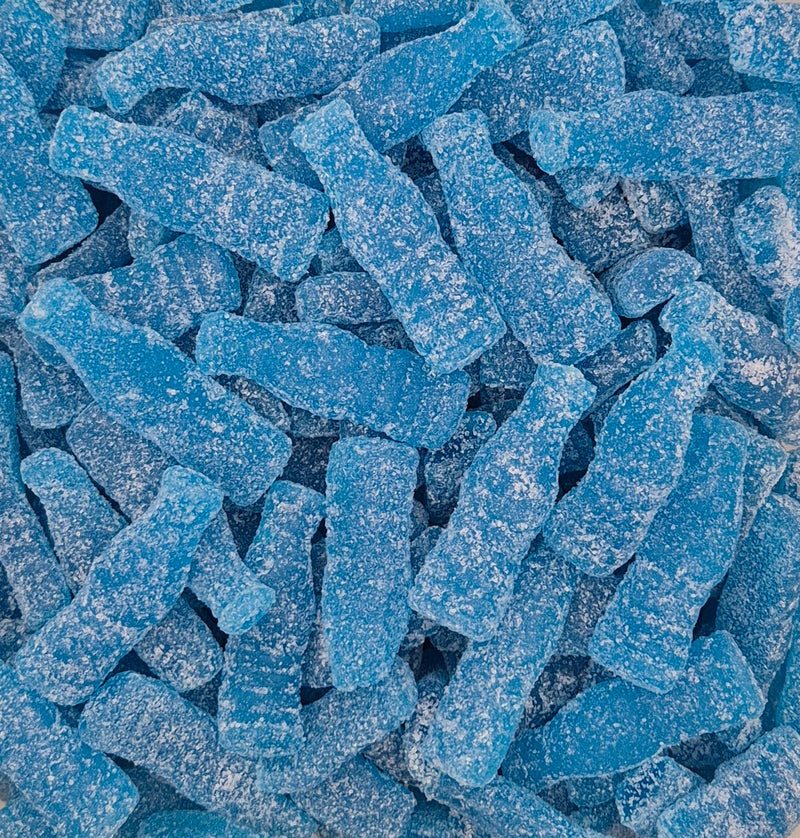 A close-up pile of blue, sugar-coated gummy candies shaped like miniature soda bottles.
